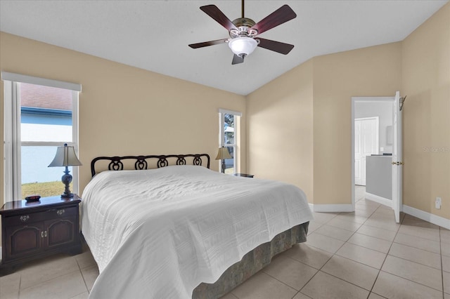 bedroom featuring ceiling fan, lofted ceiling, and light tile patterned floors