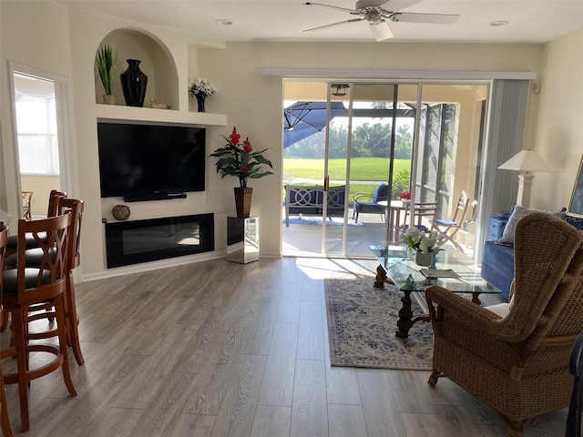 living room featuring hardwood / wood-style flooring and ceiling fan