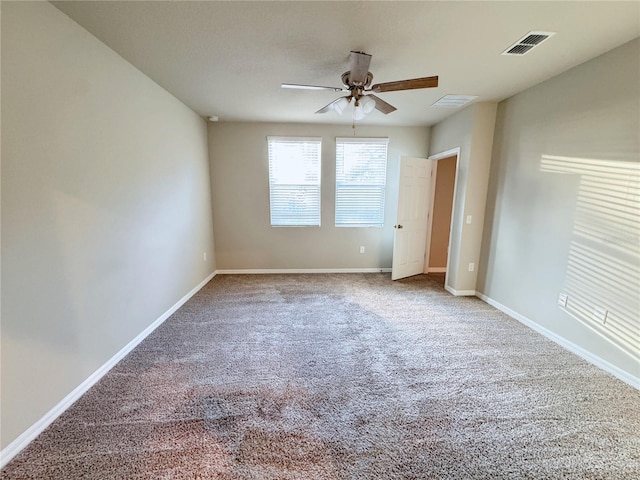 carpeted spare room with ceiling fan