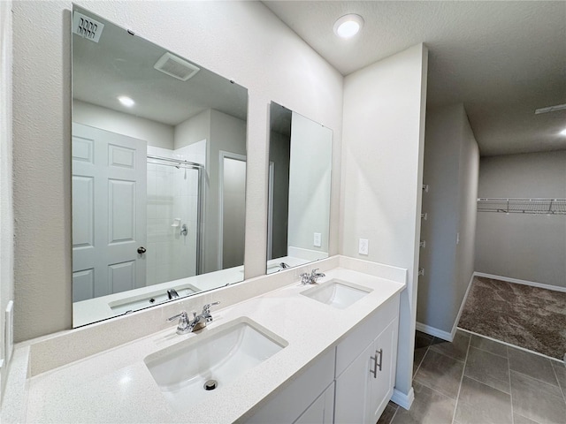 bathroom featuring vanity and a shower with door