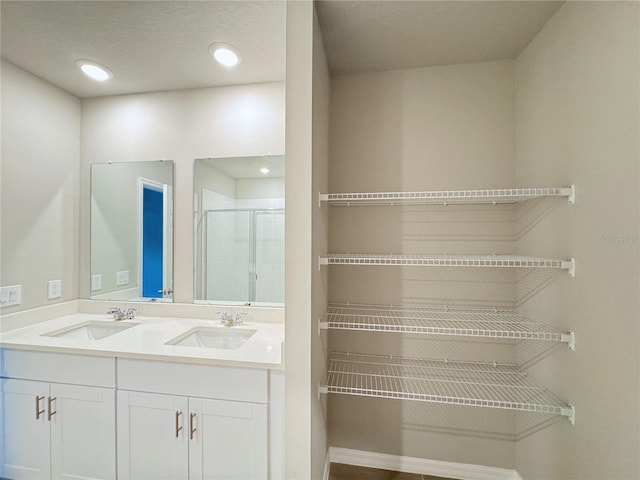 bathroom with vanity and an enclosed shower