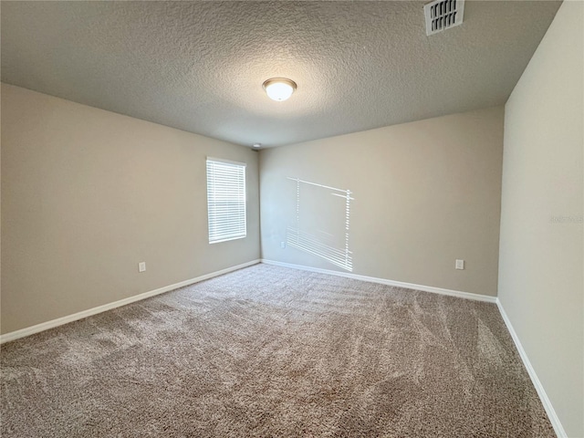 carpeted spare room with a textured ceiling