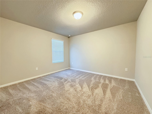 carpeted spare room featuring a textured ceiling