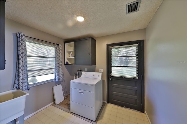 washroom featuring sink, washer / dryer, and a textured ceiling