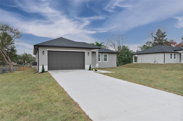 view of front of house with a garage and a front yard