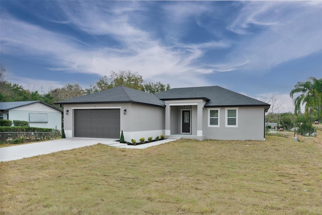 view of front of home featuring a garage and a front lawn