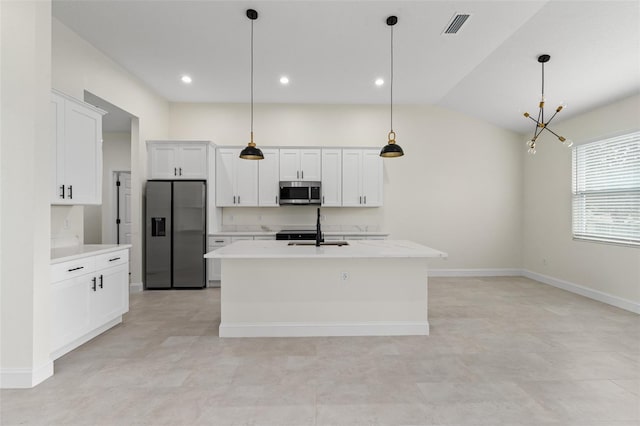 kitchen featuring sink, decorative light fixtures, a center island with sink, stainless steel appliances, and white cabinets