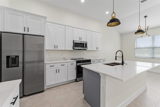 kitchen featuring appliances with stainless steel finishes, sink, a center island with sink, and white cabinets