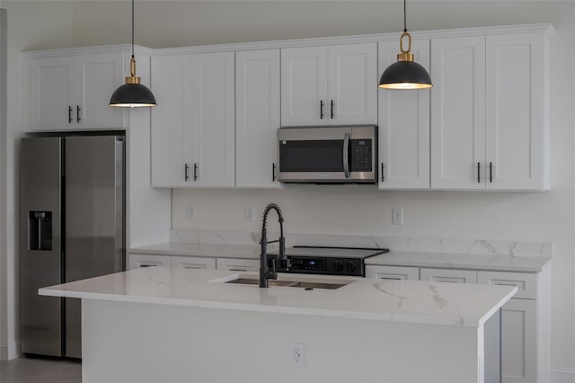 kitchen with white cabinetry, appliances with stainless steel finishes, and pendant lighting