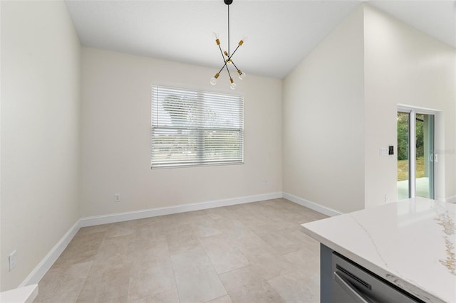 unfurnished dining area featuring lofted ceiling, plenty of natural light, and a notable chandelier