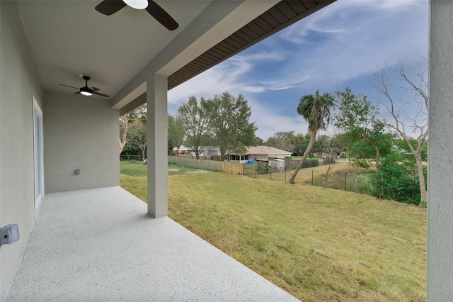 view of yard featuring ceiling fan and a patio area