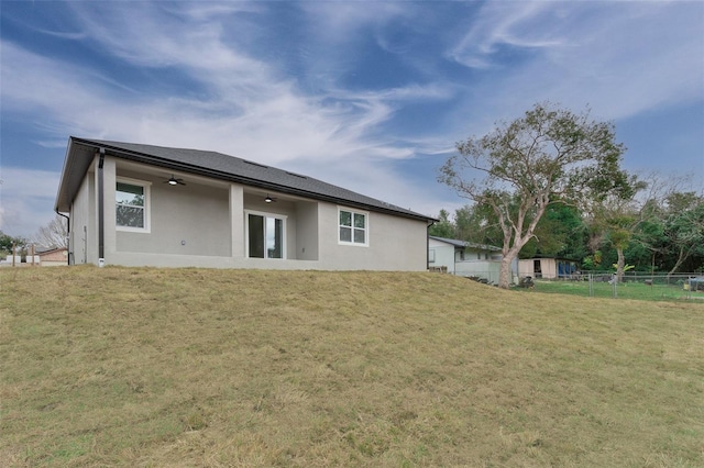 rear view of house with a lawn