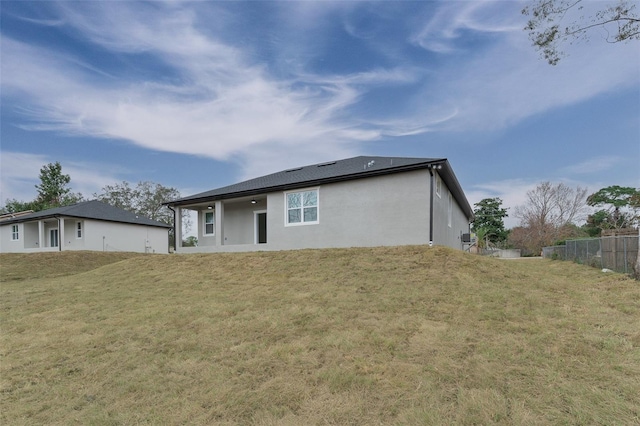 rear view of property featuring a yard