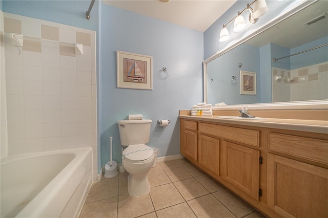 full bathroom with tile patterned flooring, vanity, tiled shower / bath, and toilet