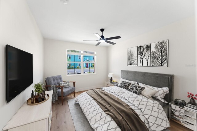 3013 Bonfire Beach Dr Unit 101, Kissimmee, FL 34746 - bedroom featuring wood finished floors, a ceiling fan, and baseboards