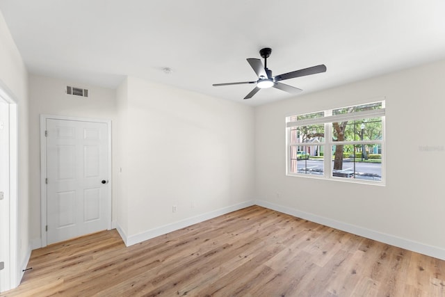 3013 Bonfire Beach Dr Unit 101, Kissimmee, FL 34746 - unfurnished room with light wood-style floors, baseboards, and ceiling fan