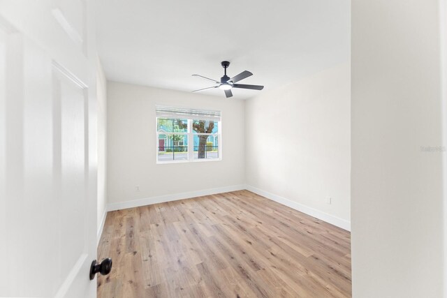 3013 Bonfire Beach Dr Unit 101, Kissimmee, FL 34746 - unfurnished room with light wood-style flooring, a ceiling fan, and baseboards