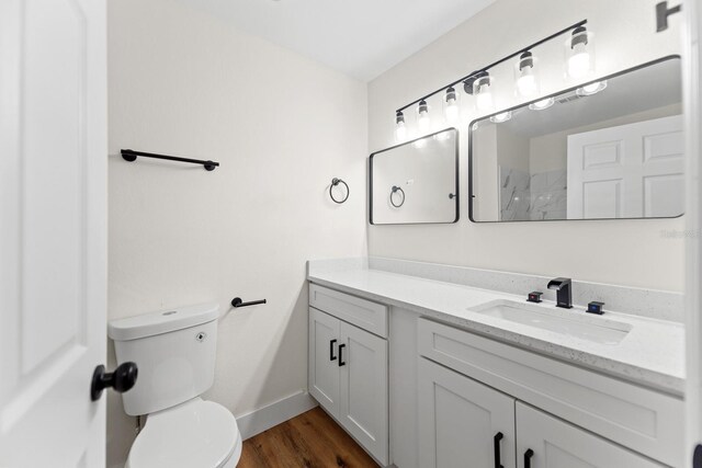 3013 Bonfire Beach Dr Unit 101, Kissimmee, FL 34746 - full bathroom with toilet, vanity, wood finished floors, a shower, and baseboards
