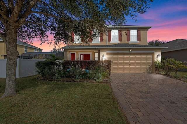 view of front facade featuring a garage and a lawn