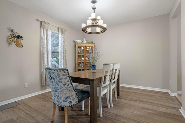 dining room with an inviting chandelier and hardwood / wood-style floors