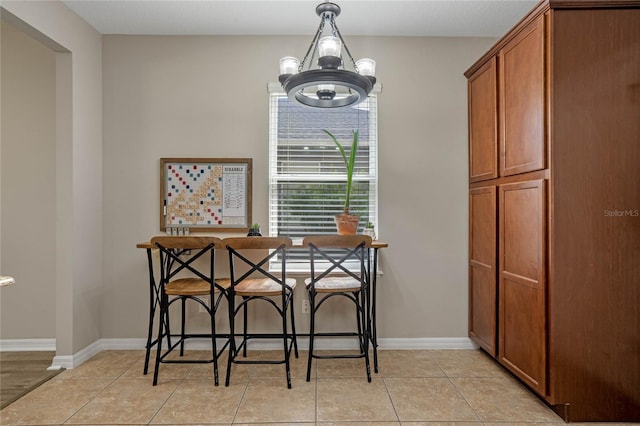 dining room featuring an inviting chandelier and light tile patterned flooring