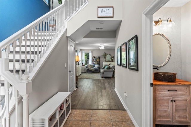 entryway featuring dark tile patterned flooring and ceiling fan