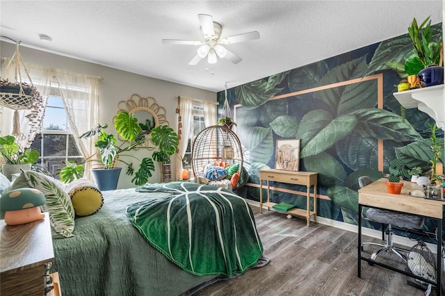 bedroom with wood-type flooring, ceiling fan, and a textured ceiling