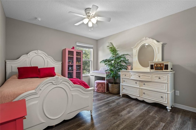 bedroom with ceiling fan, dark hardwood / wood-style floors, and a textured ceiling