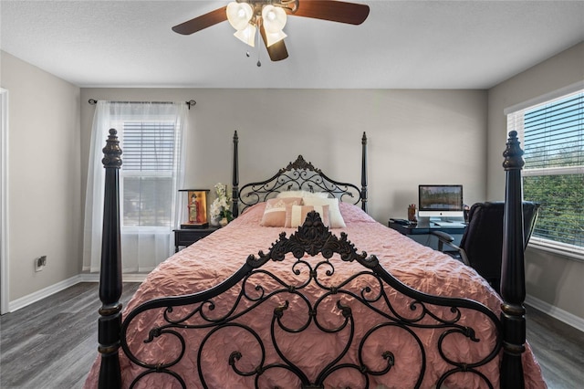 bedroom featuring ceiling fan, dark hardwood / wood-style floors, and a textured ceiling