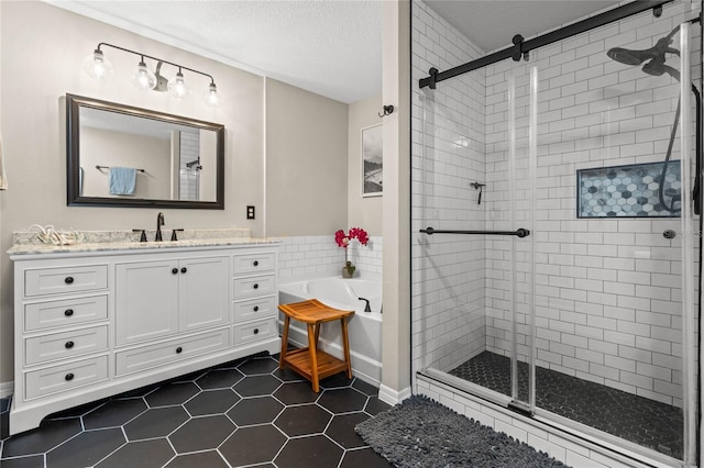 bathroom featuring tile patterned flooring, vanity, a textured ceiling, and plus walk in shower