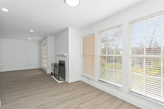 unfurnished living room with light wood-type flooring