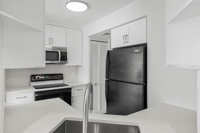 kitchen with white cabinets, sink, and black appliances