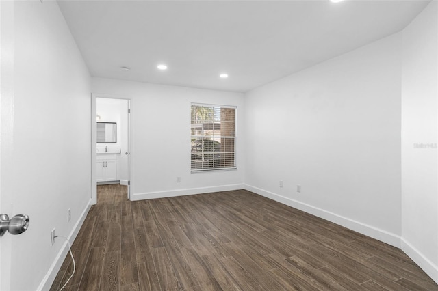 empty room with dark hardwood / wood-style floors and sink