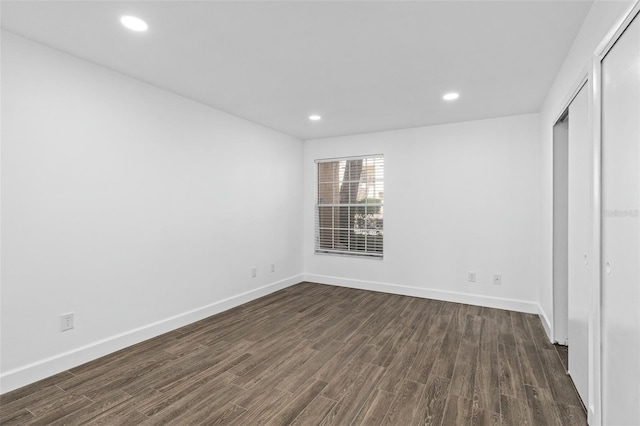 unfurnished bedroom featuring dark hardwood / wood-style floors and a closet