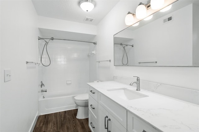 full bathroom with hardwood / wood-style flooring, vanity, toilet, and tiled shower / bath combo