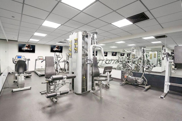 exercise room with a paneled ceiling