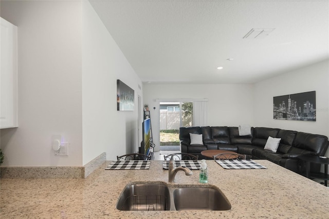 kitchen with sink and light stone counters