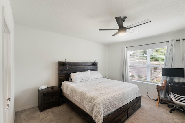 bedroom featuring light colored carpet and ceiling fan