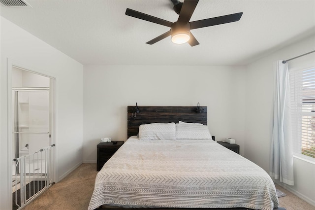 carpeted bedroom with multiple windows and ceiling fan