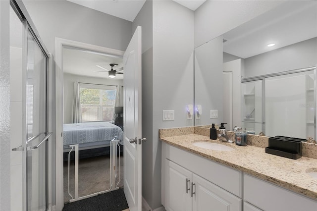 bathroom featuring vanity, ceiling fan, and walk in shower