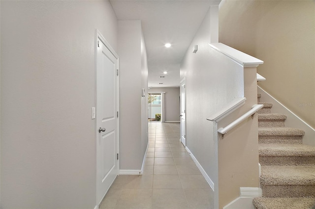 hall with light tile patterned floors