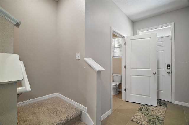 stairs with tile patterned flooring