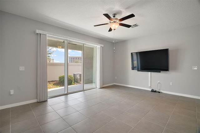 unfurnished living room featuring tile patterned flooring, a textured ceiling, and ceiling fan