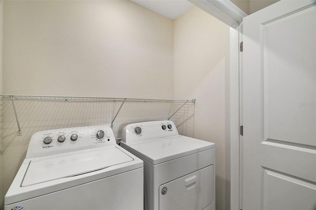 clothes washing area with washing machine and clothes dryer