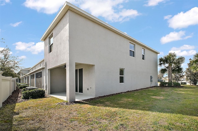 rear view of property with a patio area and a lawn