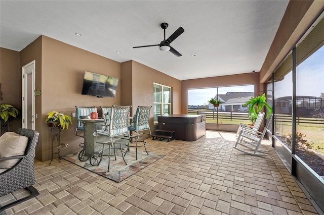 sunroom / solarium featuring ceiling fan