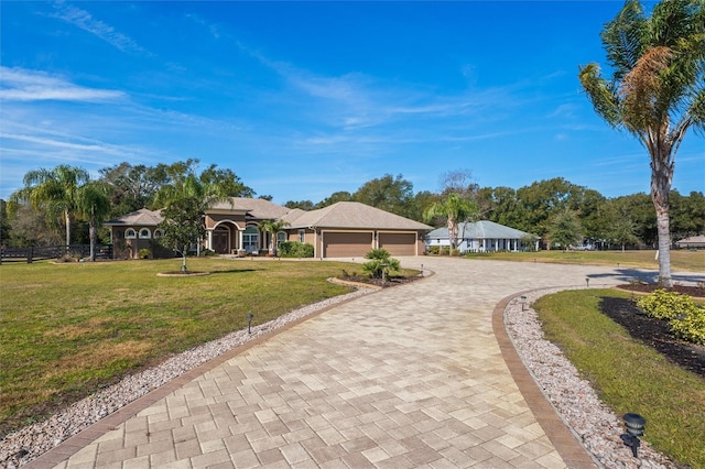 view of front of property with a garage and a front lawn