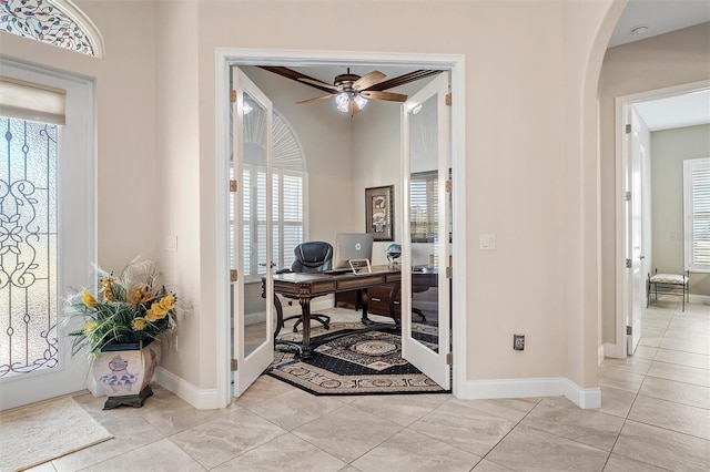 tiled office space featuring a wealth of natural light and ceiling fan