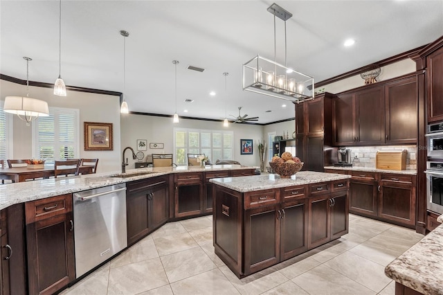 kitchen with stainless steel appliances, a center island, sink, and hanging light fixtures