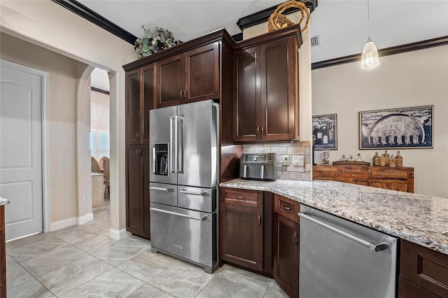 kitchen featuring light stone counters, ornamental molding, appliances with stainless steel finishes, and hanging light fixtures